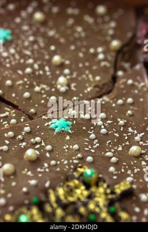 Milk chocolate bars decorated with snowflakes and white pearl beads, New Year Stock Photo
