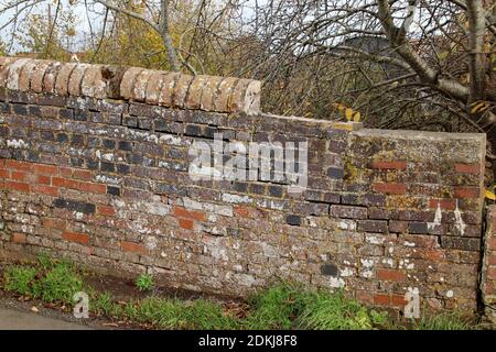 Huge cracks and missing bricks on an old brick wall Stock Photo