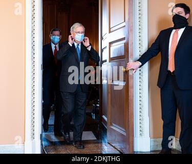 United States:  Senate Majority Leader Mitch McConnell, (R-KY) adjusting his face mask as he is leaving a press conference. Stock Photo