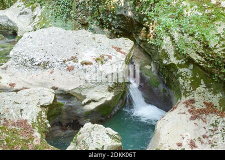 small waterfall among the gray stones Stock Photo
