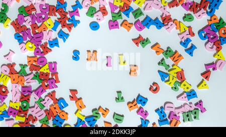 Multicolored Letters SMILE on The White Background. Letters of The Word Smile. Positive concept. Smile life is beautiful. Stock Photo