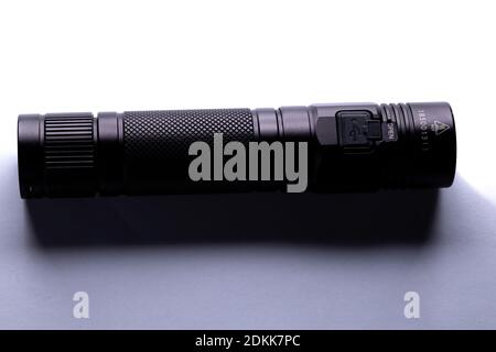 modern black metal flashlight isolated on white background Stock Photo