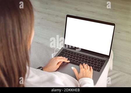 Woman working at home on a laptop. Laptop screen with copy space, mockup Stock Photo