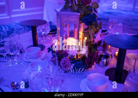 Romantic table setup for special event with candles indoor close up Stock Photo