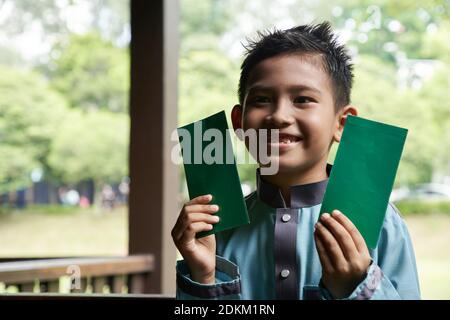 Malay Boy In A Malay Showing His Happy Face After Receiving Money Pocket On Ramadan Stock Photo Alamy