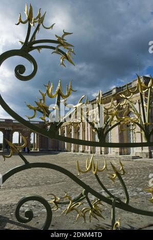 Gold painted iron gate at the Grand Trianon, Palace of Versailles, France. Stock Photo