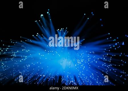 Abstract glowing fiber optic background with blue backlight Stock Photo