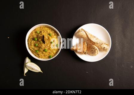 Khichdi or Khichri garnish with pea served with Papadum or papad Stock Photo