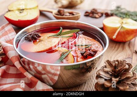 Bowl of hot mulled wine on table Stock Photo