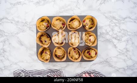 Step by step. Scooping batter with a cupcake scoop to make unicorn  chocolate cupcakes with buttercream frosting Stock Photo - Alamy