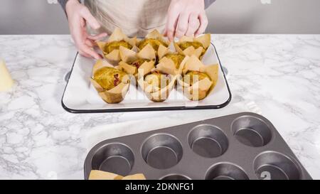 Step by step. Cooling freshly baked cranberry muffins. Stock Photo
