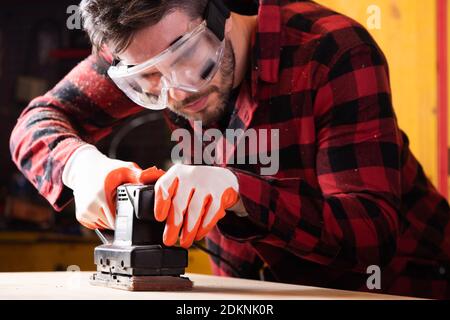 Carpenter, joiner at work in the workshop. Man at work on wood Stock Photo