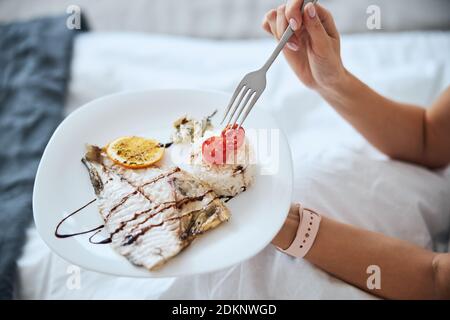 Focused photo on female hand that holding plate Stock Photo