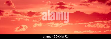 Colorful sunset - cumulus clouds painted by the setting sun. Stock Photo