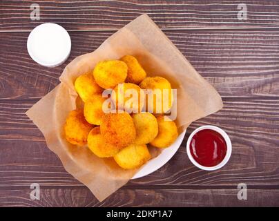 Potato croquettes balls on the plate and dips sauces. Stock Photo