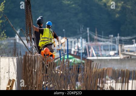 Unrecognizable builders working in port Stock Photo