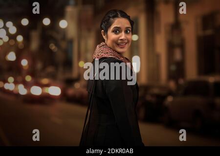 A YOUNG WOMAN TURNING AROUND AND LOOKING SURPRISED Stock Photo