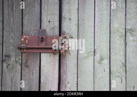 Old two rusty locks on wooden fence door. Stock Photo