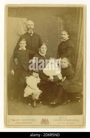 Original Victorian CDV (Carte de Visite or visiting card) of a Victorian family of 5 children, including a baby. From the studio of W. & D. Downey, (photographers to the Queen) based at London and Newcastle, dated 1883 on the front. Stock Photo