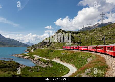 Rhaetian Railway, Bernina Express at Lago Bianco lake, Bernina Pass, Pontresina, Canton of Graubünden, Switzerland Stock Photo