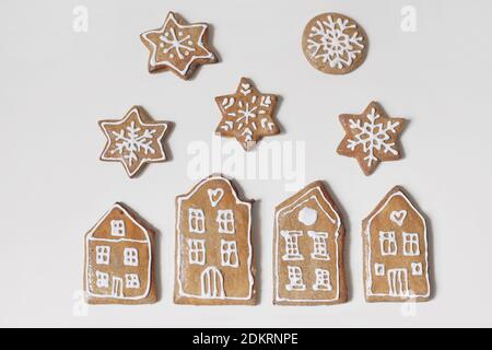 Decorative Christmas food composition. Winter border composition, banner. Star, snowflake and houses shaped gingerbread cookies isolated on white Stock Photo
