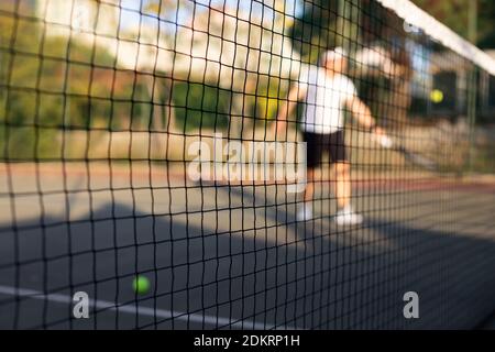 a tennis player blur after the net playing tennis day light Stock Photo