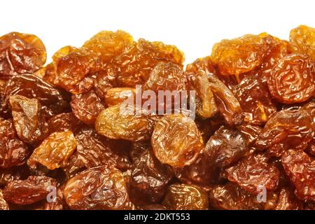 Close up of golden sultana raisins on white background, selective focus. Stock Photo