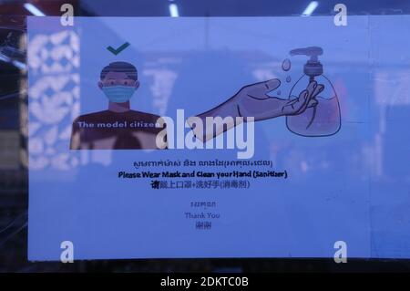 Trilingual COVID - 19 entrance sign, written in English, Khmer & Chinese, at a grocery store during the coronavirus pandemic. Steung Meanchey, Phnom Penh, Cambodia. © Kraig Lieb Stock Photo