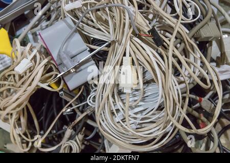 Old, obsolete computer and telephone parts and equipment about to be recycled or thrown out. Accumulation of e-waste. Stock Photo