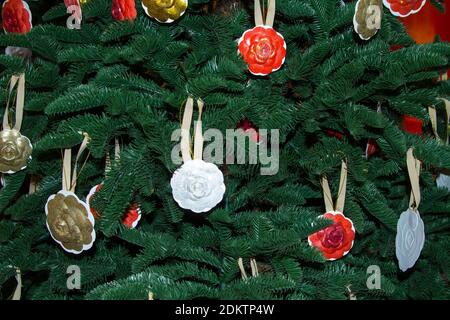 Christmas tree decor close-up with toys in the form of roses. Stock Photo