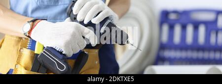 Master holds a drill in his hands. Stock Photo