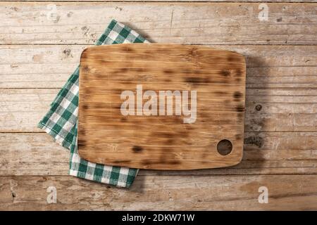 Cutting board mockup and green tablecloth on wooden table Stock Photo