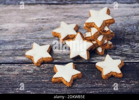 a lot of cinnamon stars on brown dark wooden background with copy space Stock Photo