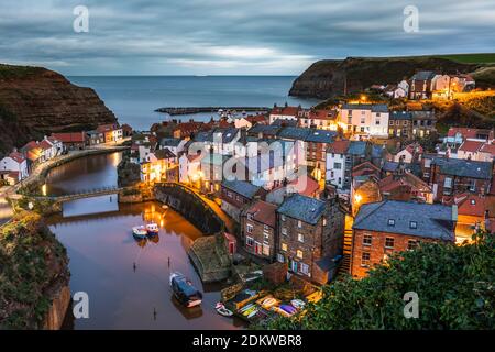 A view of Staithes in North Yorkshire, as the day transitions into night. Stock Photo