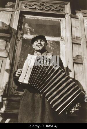 Archival photo of happy soviet collective kolkhoz farmers in the era of Stalin. From soviet propaganda book. 1930s Stock Photo