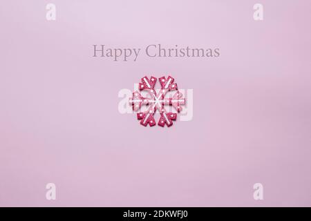 Christmas card in pink with pink snowflake decoration and Merry Christmas banner Stock Photo