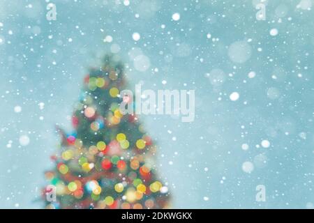 Christmas tree - blured lights and snowflakes on blue background Stock Photo