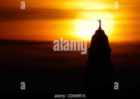 Dresden, Germany. 14th Dec, 2020. View from the Waldschlößchenbrücke to the setting sun. The tower of the town hall and town hall man can be seen only as Silhuoutte. Credit: Tino Plunert/dpa-Zentralbild/ZB/dpa/Alamy Live News Stock Photo