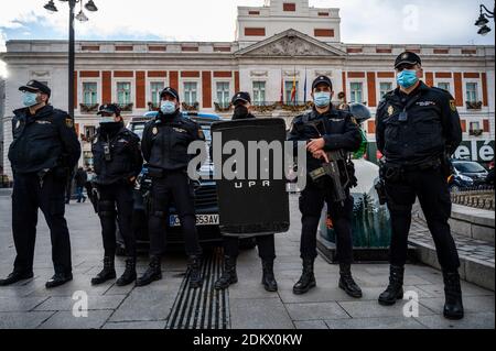 Madrid, Spain. 16th Dec, 2020. Members of U.P.R police (Prevention and Reaction Unit) wearing face masks in Sol Square during the presentation of the deployment of police for security during the Christmas celebrations. This year the police will also have to monitor that the security and restriction measures against the spread coronavirus (COVID-19) are accomplished. Credit: Marcos del Mazo/Alamy Live News Stock Photo