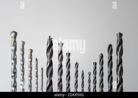 Detail of set of various drills in different sizes for wood, iron and concrete materials collocated together isolated on white background Stock Photo