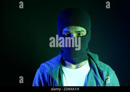Thief in a mask on black background close up, Stock Photo