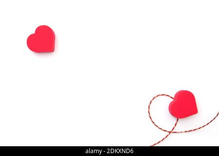 Two red hearts on white surface, layout, space for text. Postcard for Valentine's day or wedding celebration Stock Photo