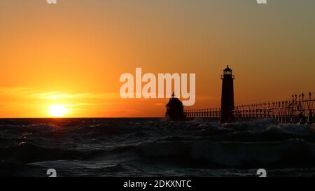 Grand Haven South Pier Lighthouse at sunset on Lake Michigan, on a windy day Stock Photo