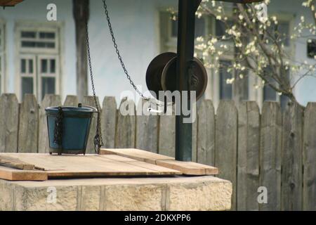 Vrancea County, Romania. Authentic water well with wheel and  bucket. Stock Photo