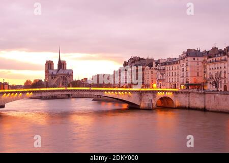 Apartments on Ile Saint Louis, Notre Dame Cathedral on Ile de la Cite and Pont de la Tournelle bridge over Seine river, Paris, France Stock Photo