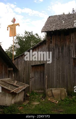 Simple scarecrow in a yard in Romania's countryside Stock Photo