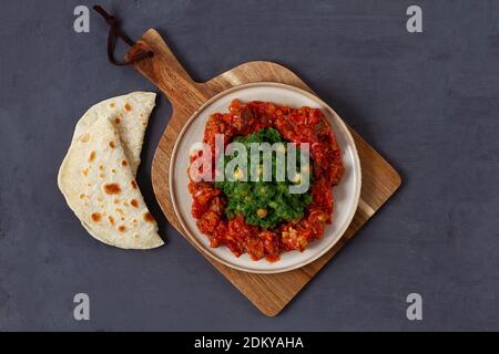 Mukimo, Kenya cuisine, meat stew, with chapatis on a dark background, top view, no people, horizontal,