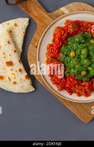 Mukimo, Kenya cuisine, meat stew, with chapatis on a dark background, top view, no people, horizontal,