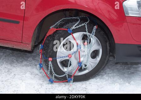 putting on snow chains on a car, road safety in winter Stock Photo