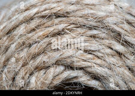 High-quality handmade coil made of natural hemp rope, isolated on a white background. Rustic beige cord made of eco material Stock Photo